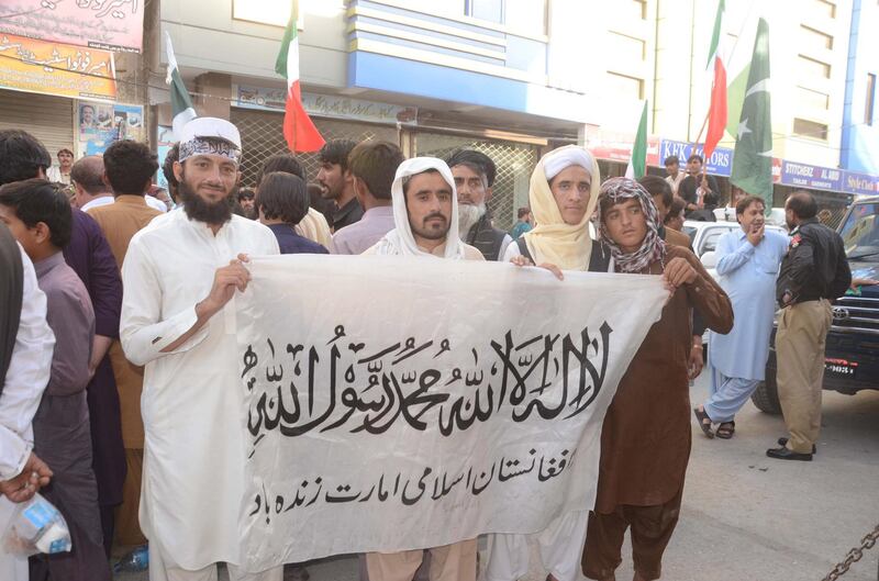 epa08603378 Supporters of Afghan Taliban hold the Taliban's flag, as they attend a rally to mark the Pakistan's Independence Day celebrations in Quetta, Pakistan, 14 August 2020. Millions of Pakistanis celebrate the 74th independence from British rule on 14 August 2020  EPA/JAMAL TARAKAI