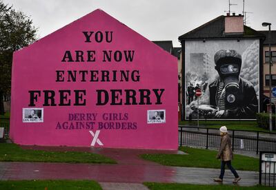 LONDONDERRY, NORTHERN IRELAND - OCTOBER 09: A woman walks past a mural that states 'Derry Girls Against Borders' at Free Derry Corner on October 9, 2018 in Londonderry, Northern Ireland. Talks on the Irish border are thought to be at a crucial stage as the EU and the UK attempt to resolve their differences over the backstop plan to avoid a hard border between the Republic of Ireland and Northern Ireland which is part of the United Kingdom. EU officials had expressed optimism at the weekend regards a Brexit deal being struck by the end of the year. (Photo by Charles McQuillan/Getty Images)