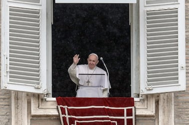 Pope Francis waves after reciting the Angelus prayer from his studio window overlooking St. Peter's Square, at the Vatican. AP