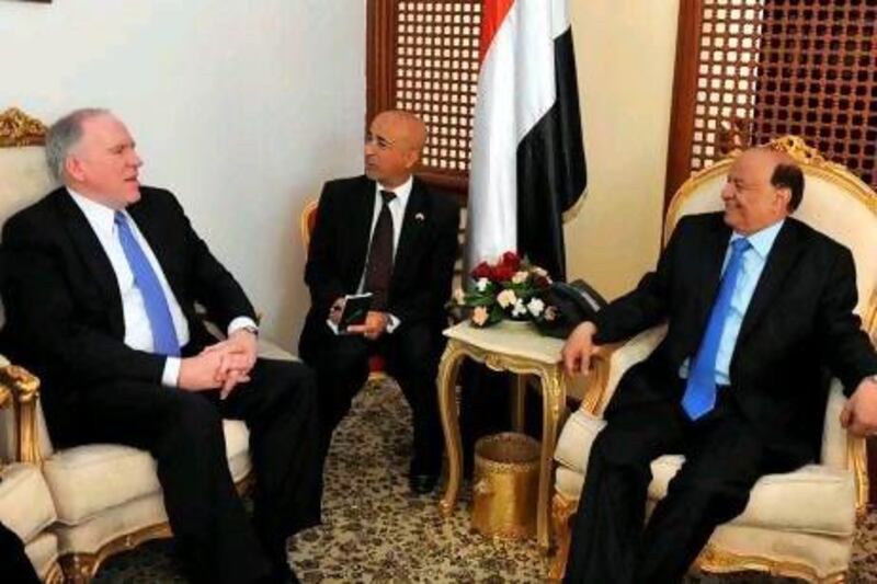 The US counterterrorism chief, John Brennan, left, conveyed a message of thanks from the US president, Barack Obama, to the Yemeni president, Abdrabu Mansur Hadi, right, for his antiterrorism measures.