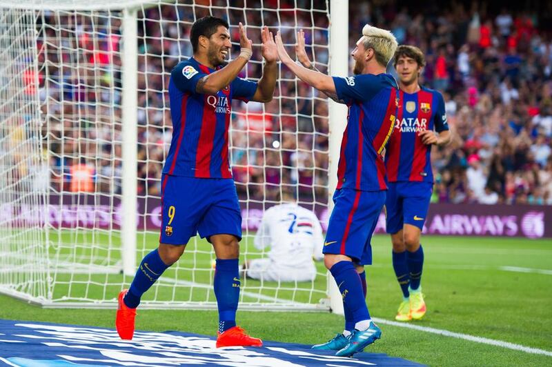 Luis Suarez, left, of Barcelona celebrates with his teammate Lionel Messi after scoring the opening goal during the Joan Gamper trophy match between Barcelona and UC Sampdoria in August. Alex Caparros / Getty Images