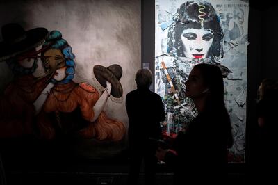 Works by Miss Van (L) and Stikky Peaches are on display at the Urban Nation Museum for Urban Contemporary Art in Berlin on September 15, 2019. (Photo by John MACDOUGALL / AFP) / RESTRICTED TO EDITORIAL USE - MANDATORY MENTION OF THE ARTIST UPON PUBLICATION - TO ILLUSTRATE THE EVENT AS SPECIFIED IN THE CAPTION