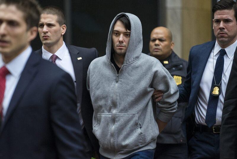 Martin Shkreli, the former hedge fund manager under fire for buying a pharmaceutical company and ratcheting up the price of a life-saving drug by 5000%, is escorted by law enforcement agents in New York on unrelated fraud charges. Craig Ruttle / AP Photo