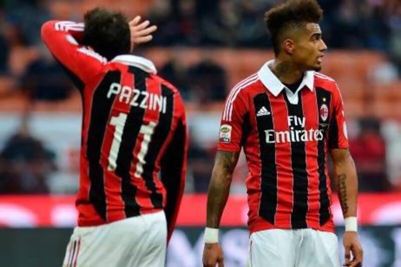 AC Milan's forward Giampaolo Pazzini (L) and Ghanaian forward Prince Kevin Boateng react during an Italian Serie A football match between Ac Milan and Siena on January 6, 2013 at San Siro stadium in Milan. AFP PHOTO / ALBERTO PIZZOLI
 *** Local Caption *** 204620-01-08.jpg