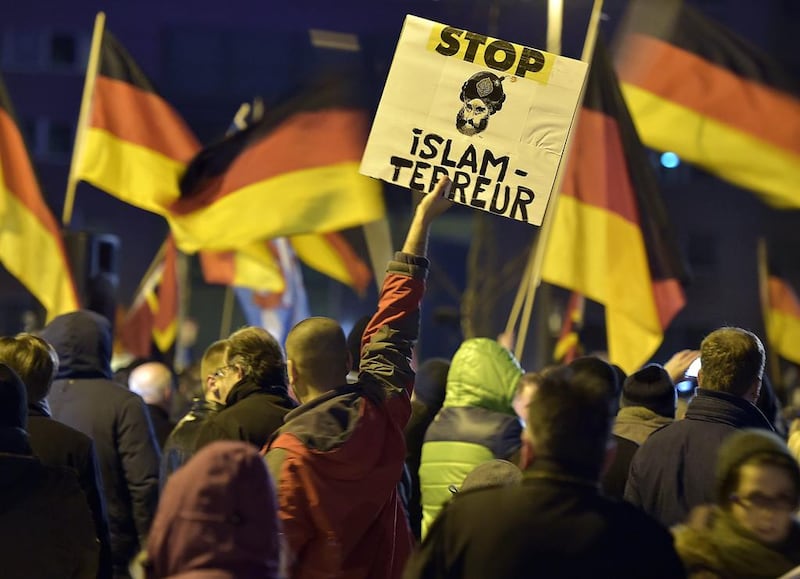 A Pegida supporter holds a banner advocating against "Islamic terror" at a protest in Cologne on Monday. (Martin Meissner/AP)