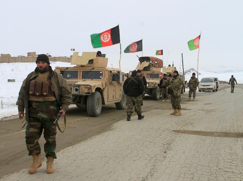 Afghan National Army forces go towards the site of an airplane crash in Deh Yak district of Ghazni province. Reuters