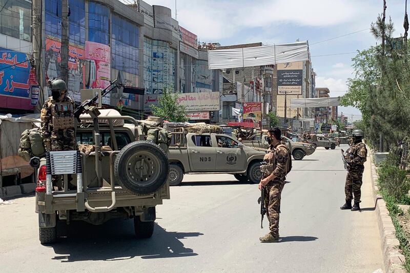 Afghan security personnel arrive at the site where gunmen attacked, in Kabul, Afghanistan. AP Photo