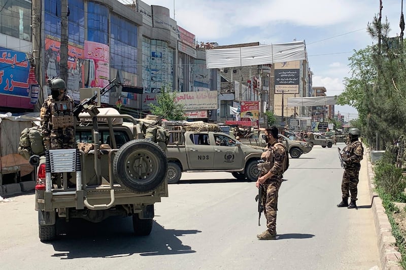 Afghan security personnel arrive at the site where gunmen attacked, in Kabul, Afghanistan. AP Photo