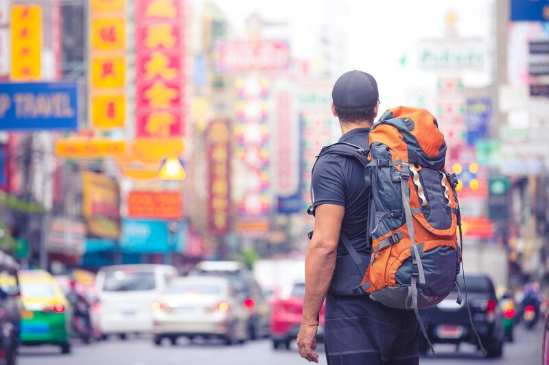 tourist backpacker visiting a city in southeast asia . .