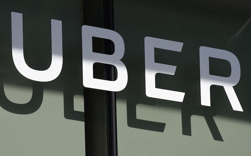 (FILES) In this file photo taken on May 08, 2018, the Uber logo is seen at the second annual Uber Elevate Summit at the Skirball Center in Los Angeles, California. - Uber on Wednesday, August 15, 2018 disclosed that its quarterly loss jumped despite taking in more money, as it invested in scooters and other "big bets." The San Francisco-based smartphone ride star reported it lost $891 million on net revenue of $2.8 billion, while overall bookings rose to $12 billion. (Photo by Robyn Beck / AFP)