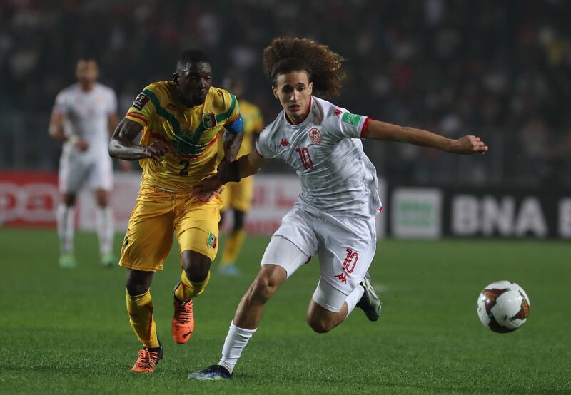 Tunisia's Hannibal Jegham shrugs off the challenge of Hamari Traore of Mali. EPA