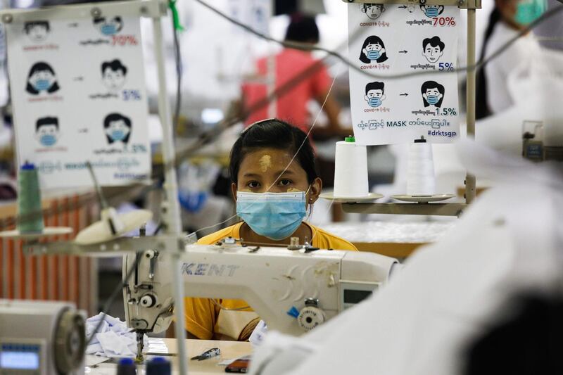 A worker sews disposable surgical gowns for health workers at a garment factory in Yangon. AFP