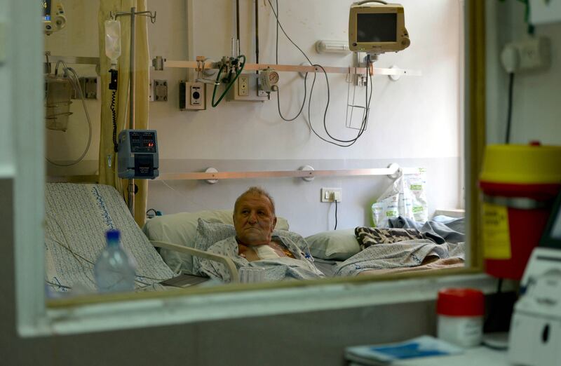 A patient receives treatment at the hospital. It was set up in 1968 and is considered one of the most important and leading medical institutions in Palestine, but it suffers from high debts. Photo: Getty Images