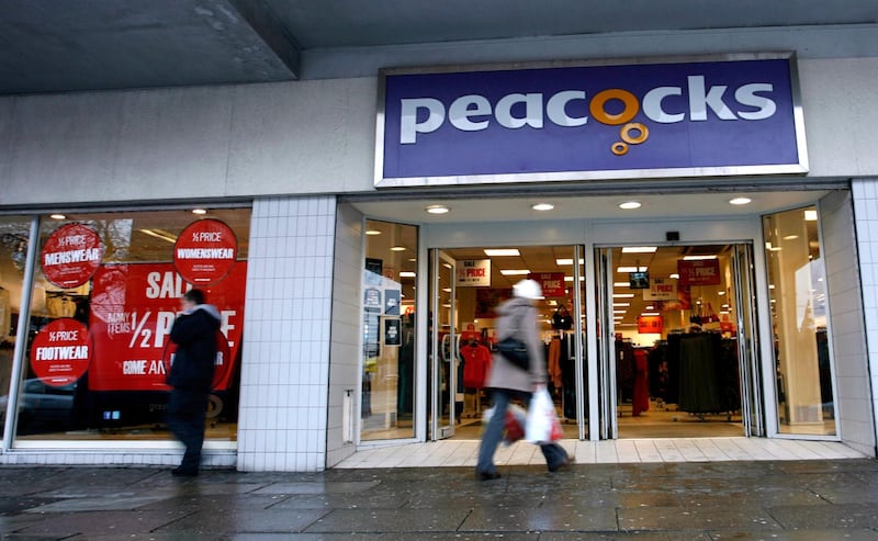 Pedestrians pass a Peacocks store, operated by Peacocks Stores Ltd., in Liverpool, U.K., on Friday, Dec. 16, 2011. U.K. retail sales fell more than economists forecast in November as cash-strapped households shunned a second month of price discounts and chose to save rather than spend amid warnings of a looming recession. Photographer: Paul Thomas/Bloomberg