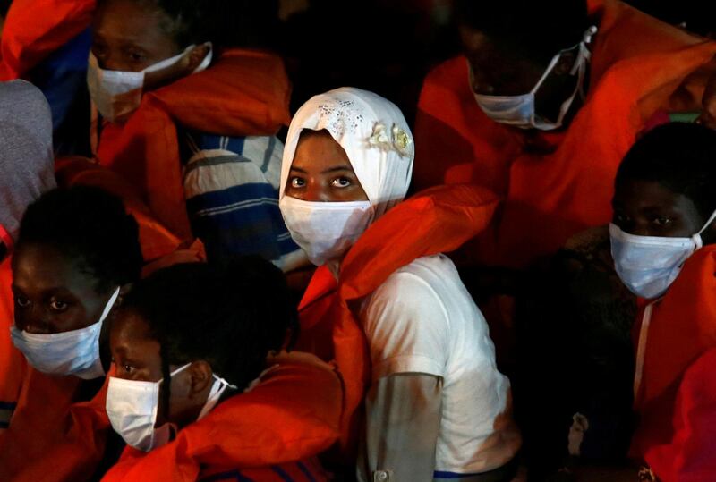 Rescued migrants look on from onboard an Armed Forces of Malta vessel upon their arrival in Senglea, in Valletta's Grand Harbour, as the coronavirus disease (Covid-19) outbreak continues in Malta. Reuters
