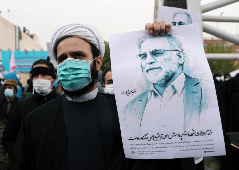 A protester holds a picture of Mohsen Fakhrizadeh, Iran's top nuclear scientist, during a demonstration against his killing in Tehran. WANA via REUTERS