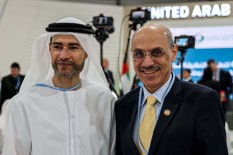Muhammad Sulaiman Al Jasser, right, chairman of the Islamic Development Bank Group, poses for a photo with Mohamed Hadi Al Hussaini, the UAE's Minister of State for Financial Affairs. AFP