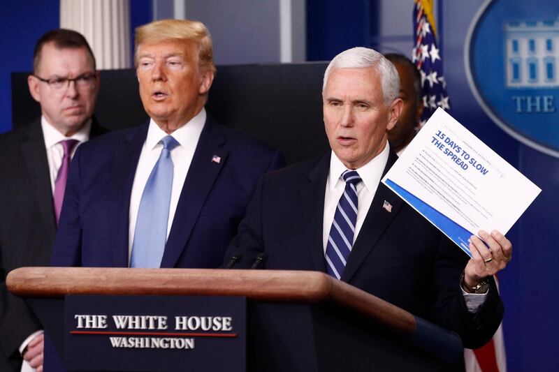 Vice President Mike Pence speaks as President Donald Trump listens during a coronavirus task force briefing at the White House, Saturday, March 21, 2020, in Washington. (AP Photo/Patrick Semansky)