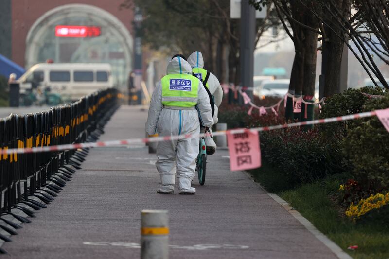Security guards patrol an area of Xi’an that is under restrictions after the recent coronavirus outbreak. AFP
