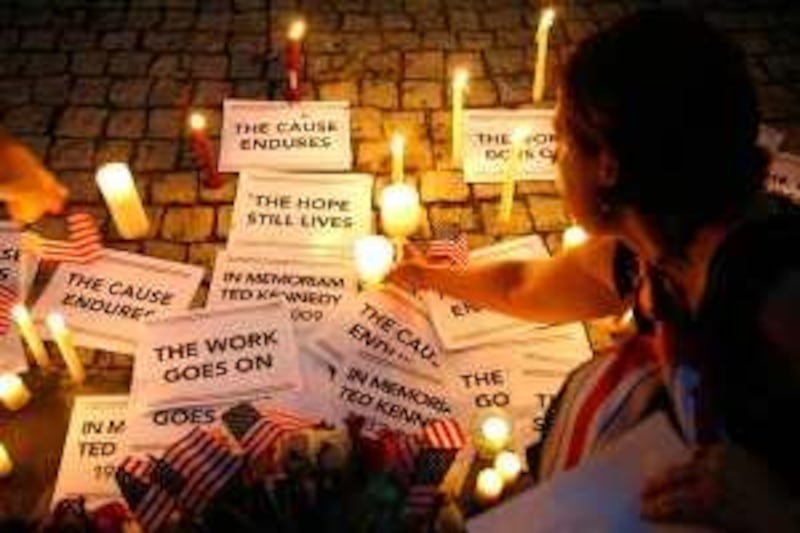 WASHINGTON - AUGUST 26: A woman put a candle down at a makeshift shine during a candlelight vigil in memory of U.S. Sen. Edward Kennedy (D-MA) at Dupont Circle August 26, 2009 in Washington, DC. Kennedy has passed away at the age of 77 at his home in Hyannis Port, Massachusetts after battling a brain cancer.   Alex Wong/Getty Images/AFP *** Local Caption ***  671266-01-10.jpg