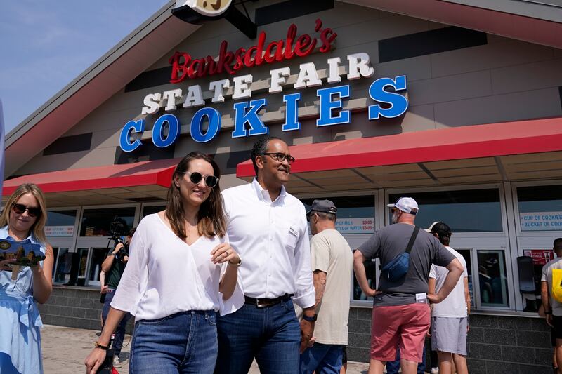 Republican presidential candidate and former Texas representative Will Hurd and his wife Lynlie walk past a cookie shop. AP
