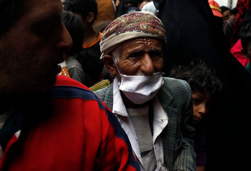 A Yemeni waits to receive rations in Sanaa. EPA