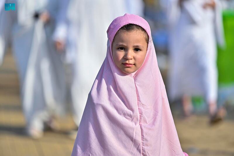 A little girl dressed in Hajj clothing poses for the camera. SPA