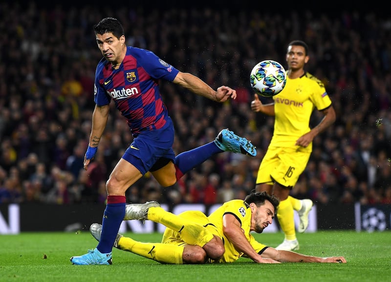 Barcelona's Luis Suarez is tackled by Mats Hummels of Dortmund. Getty