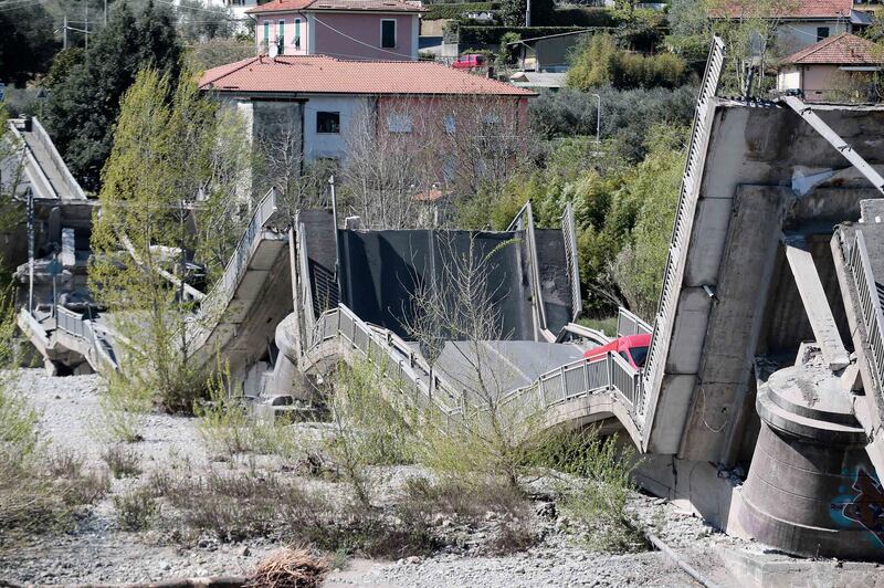 A red van is partially seen by the debris of a collapsed bridge, in Aulla, between the regions of Tuscany and Liguria, northern Italy,  AP