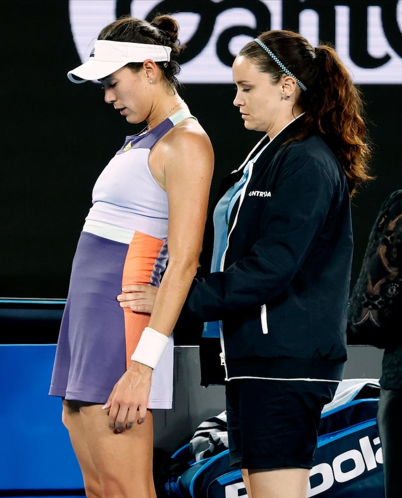 Garbine Muguruza receives medical attention. AP