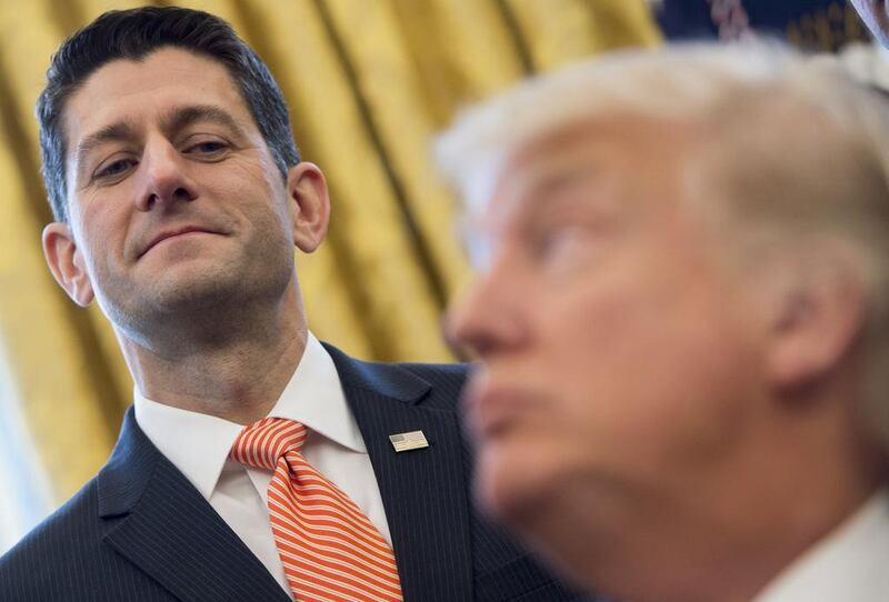 US President Donald Trump speaks to Speaker of the House Paul Ryan after signing House Joint Resolution 41 in the Oval Office of the White House in Washington DC. Saul Loeb / AFP Photo