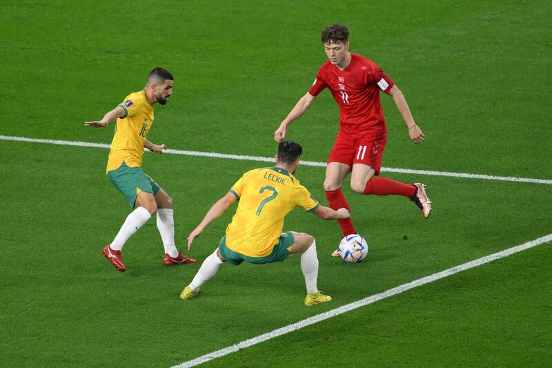 Australia's Aziz Behich and Mathew Leckie block Andreas Skov Olsen's run. AFP