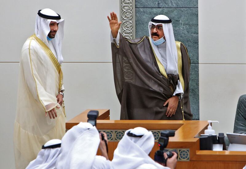 The new Kuwaiti Crown Prince Sheikh Meshal Al Ahmad Al Jaber Al Sabah, right, gestures next to Parliament speaker Marzouq Al Ghanem as he takes the oath at parliament, in October 2020. AFP