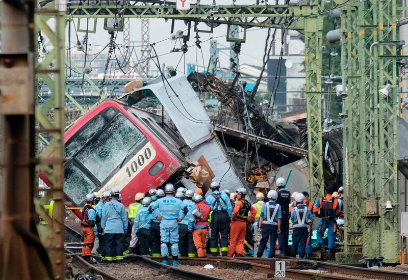 A train is seen derailed after a collision with a truck at a crossing in Yokohama, Kanagawa Prefecture.  AFP