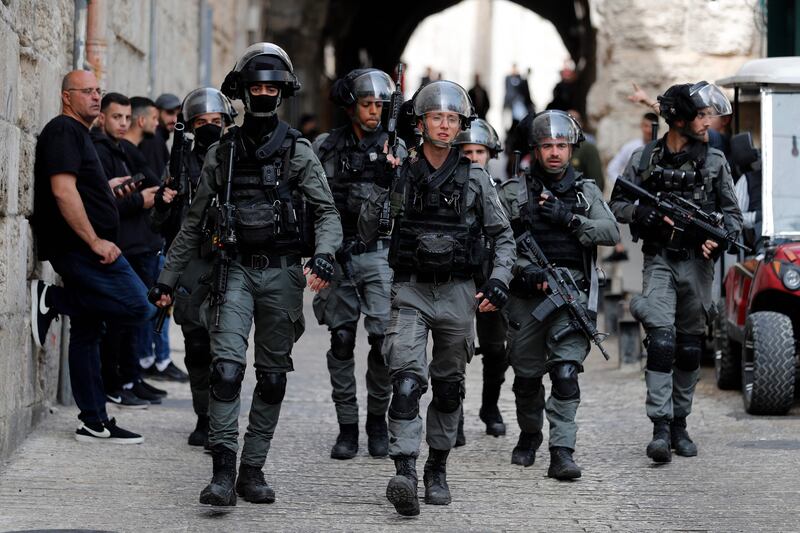 Israeli border police on patrol at the Lion's Gate in Jerusalem's Old City, as Palestinians wait to be allowed to enter the Al Aqsa Mosque compound. AFP