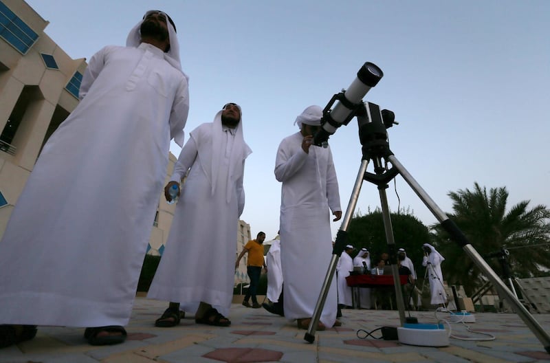 Men gather to sight the new crescent moon atop of Jebel Hafeet in Al Ain.  EPA