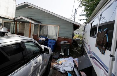 A vehicles are parked outside the home of Paige A. Thompson, who uses the online handle "erratic," Wednesday, July 31, 2019, in Seattle. Thompson was taken into custody Monday at the home and has been charged with a single count of computer fraud and abuse in U.S. District Court in Seattle. (AP Photo/Ted S. Warren)