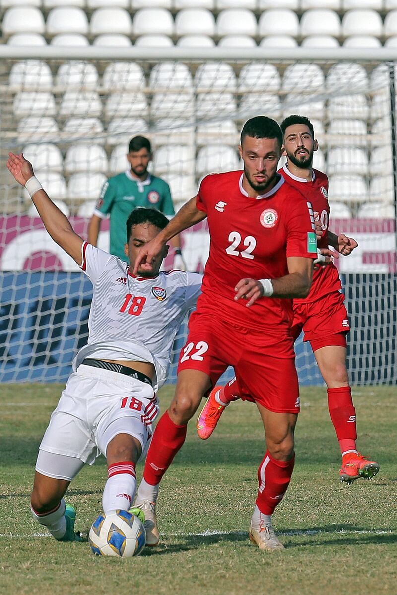 UAE's midfielder Abdullah Ramadan challenges Bassel Jradi of Lebanon. AFP