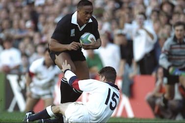 All Blacks great Jonah Lomu charges through the tackle of England's Mike Catt to score one of his four tries during the Rugby World Cup semi-final in Cape Town in 1995. Getty