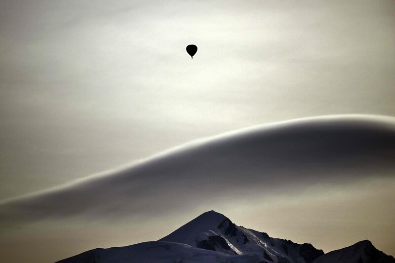 A hot air balloon drifts above the Mont Blanc mountain range in the French Alps. AFP