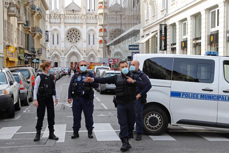 French policemen stand guard in the street leading to the church. AFP