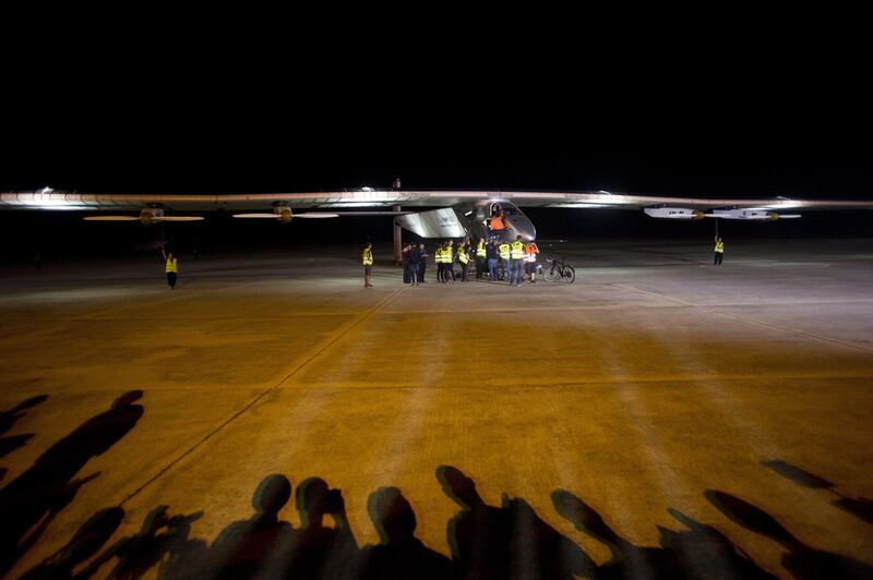 Support crew members of Solar Impulse 2 attend to the plane before it takes off from Mandalay International Airport in Myanmar. AFP