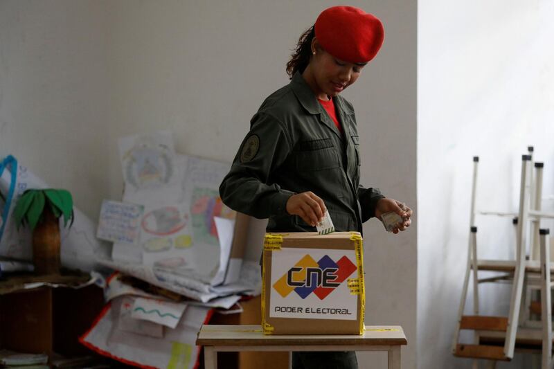 A Venezuelan soldier casts her vote at a polling station during the municipal legislators election in Caracas, Venezuela December 9, 2018. REUTERS/Marco Bello TPX IMAGES OF THE DAY