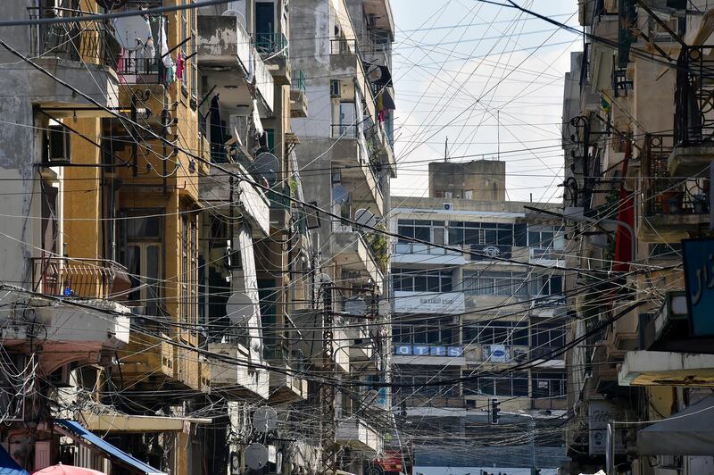 epa06920403 Electric wires connected to a generator which runs when the national power grid is down in one of Tripoli's heavily populated neighbourhoods, north Lebanon, 30 July 2018 (Issued 31 July 2018). The insufficient electricity supply has been a problem ever since the civil war, more than fourty years ago, and accompanied by a lack of practical solutions aswell.  EPA/WAEL HAMZEH