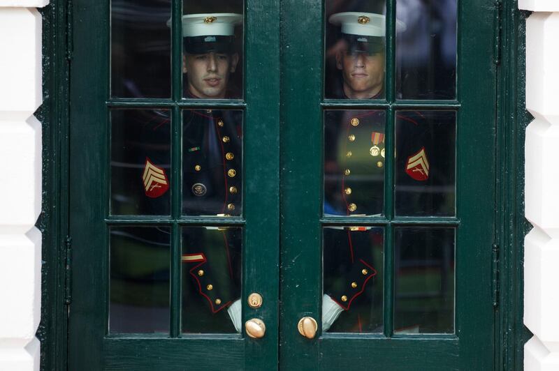 US marines prepare to open a door for the arrival of President Donald Trump. AFP