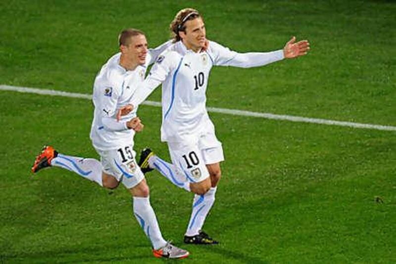 Uruguay's Diego Forlan celebrates after scoring his second against South Africa last night.