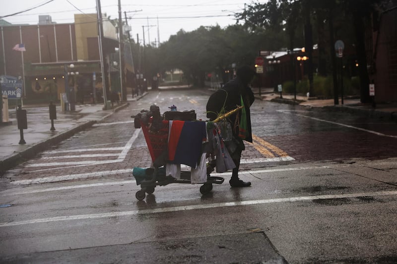 A man carries his belongings across the street in Ybor City, Tampa. Reuters
