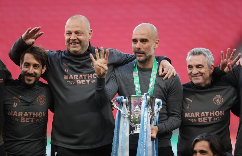 Manchester City manager Pep Guardiola, second right, celebrates after his team secured their fourth consecutive League Cup final win. Reuters