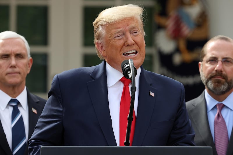 U.S. President Donald Trump is flanked by Vice President Mike Pence and Health and Human Services (HHS) Secretary Alex Azar during a news conference where the president declared the coronavirus pandemic a national emergency in the Rose Garden of the White House in Washington, U.S., March 13, 2020. REUTERS/Jonathan Ernst