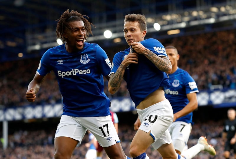 Everton's Bernard, right, celebrates scoring his side's first goal of the game against West Ham, with teammate Alex Iwobi, left, during their English Premier League soccer match at Goodison Park in Liverpool, England, Saturday Oct. 19, 2019. (Martin Rickett/PA via AP)